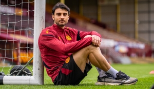 Johnny Koutroumbis ahead of Hibernian